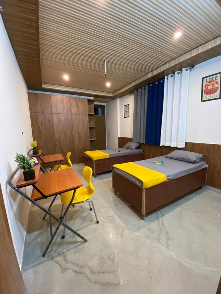 A modern, secure boys' hostel building in E-11, Islamabad, with male students interacting in a common area, highlighting a safe and social environment.